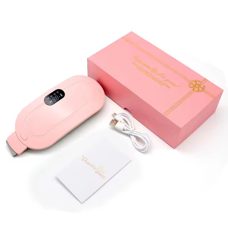 شکم بند تسکین درد با پشت زمینه ی سفید به همراه جعبه و دفترچه راهنما و کابل شارژ