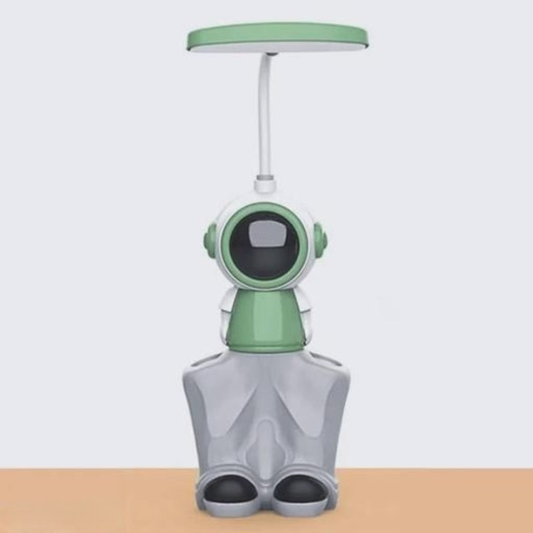 چراغ مطالعه رو میزی ۳ کاره مدل فضانورد رنگ سبز روی میز چوبی